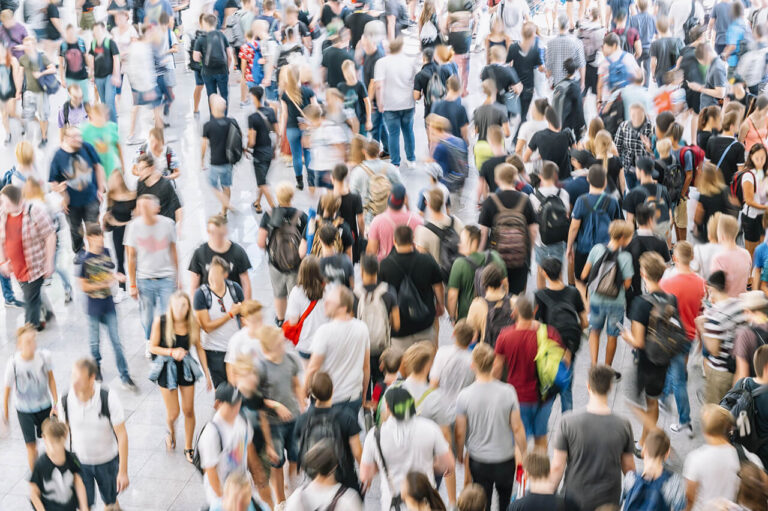Blurry crowd of people in a city setting