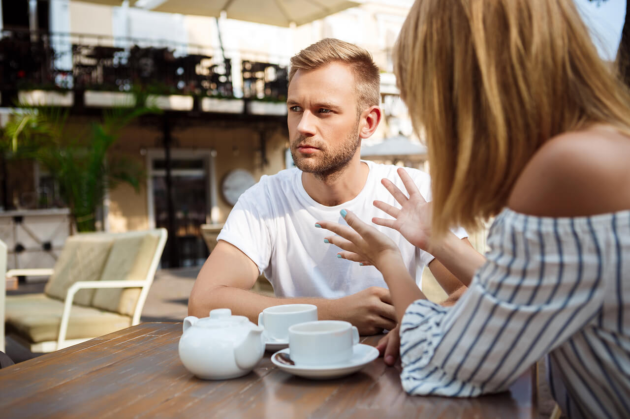 Young couple arguing in a cafe